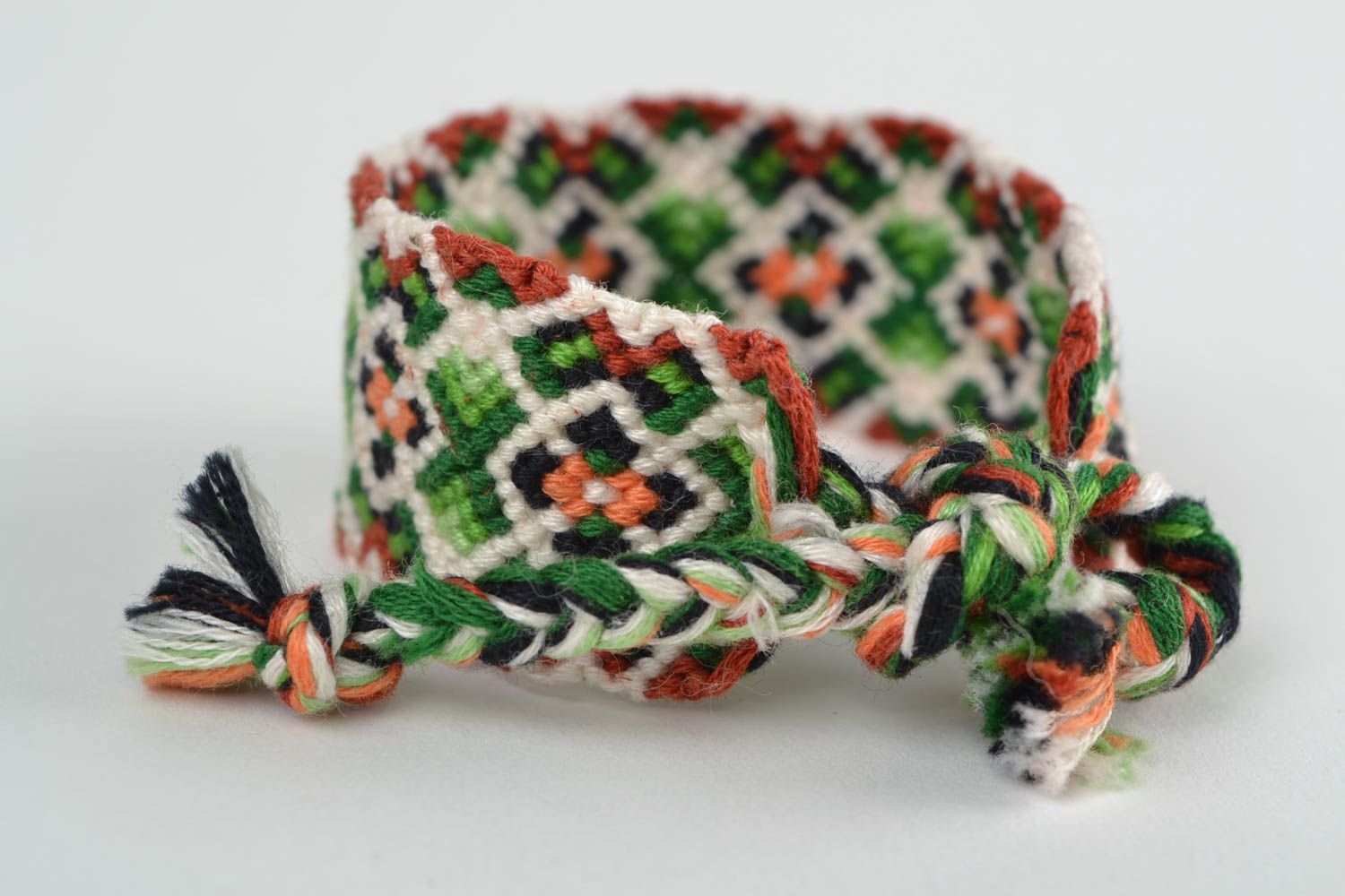 Handmade designer friendship bracelet with green and white geometric ornament  photo 4