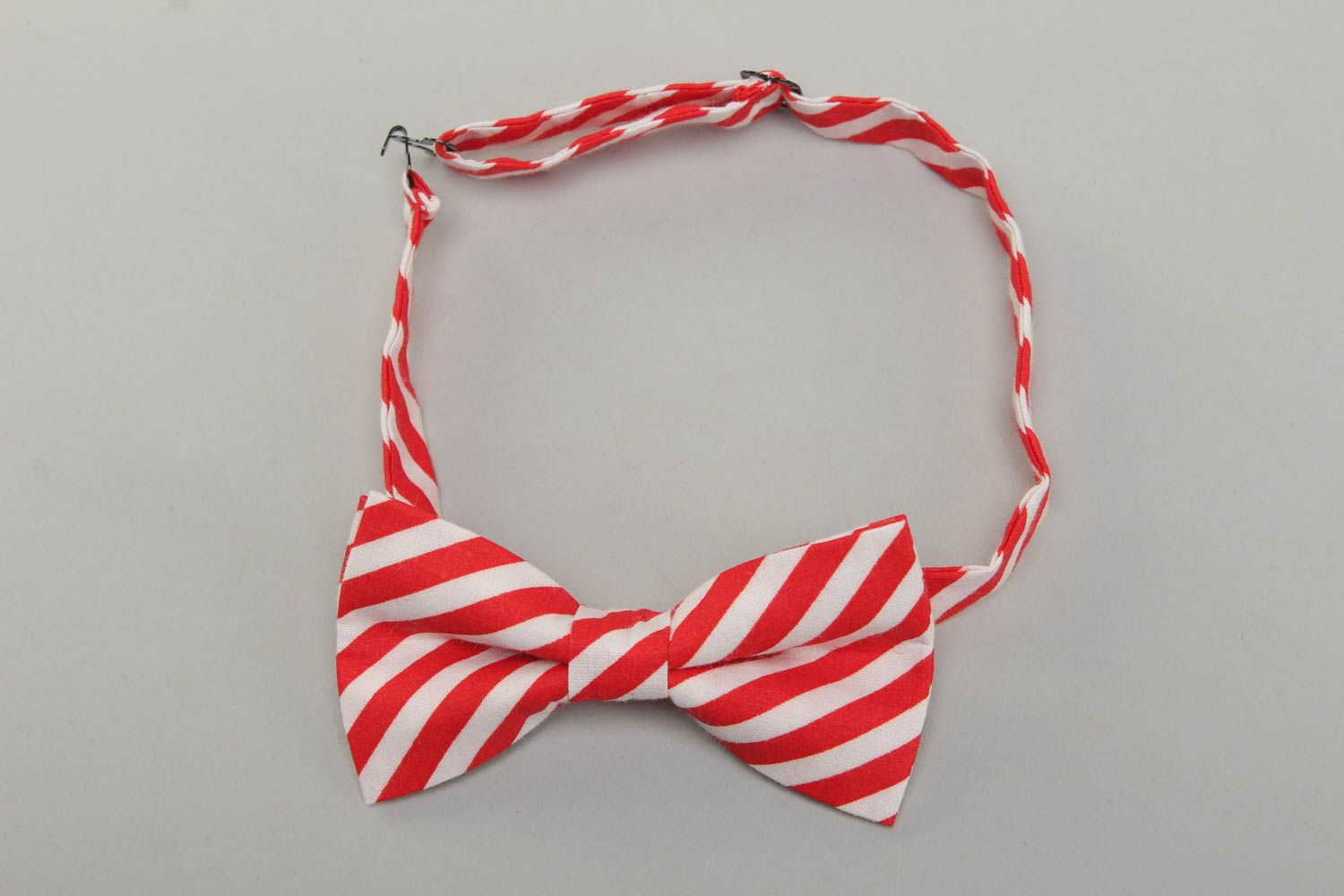 Bow tie made of white and red striped cotton fabric photo 1