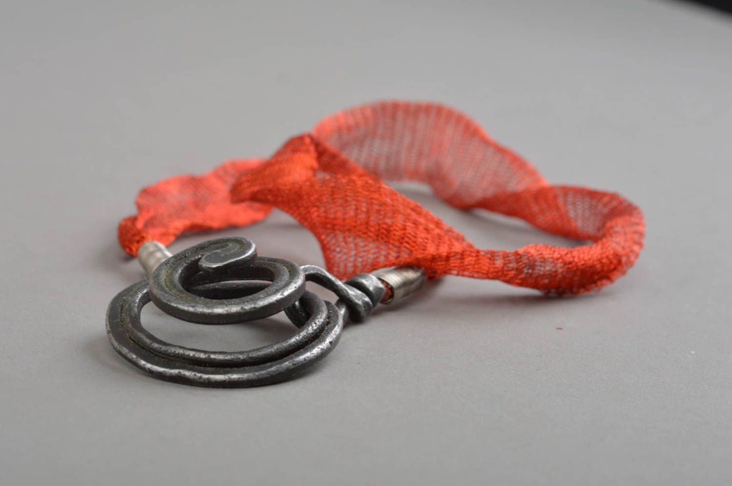 Necklace on red lace with manually forged pendant made of iron Whirl anthracite photo 4