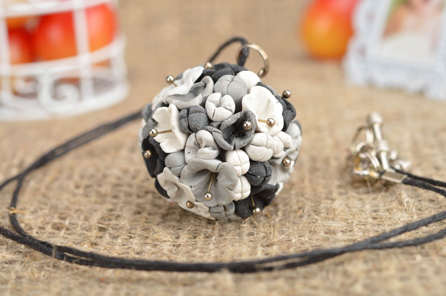 Handmade pendant made of polymer clay in form of grey flowers on cord photo 1
