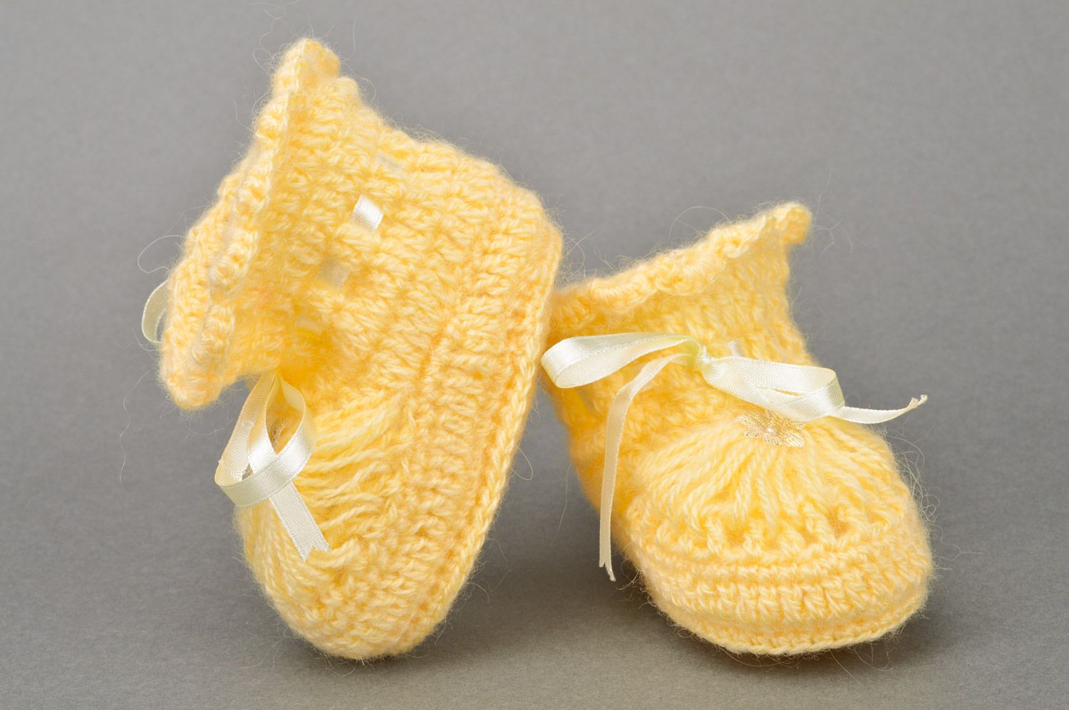 Handmade crocheted yellow baby booties made of acrylic with ribbon for girls photo 2