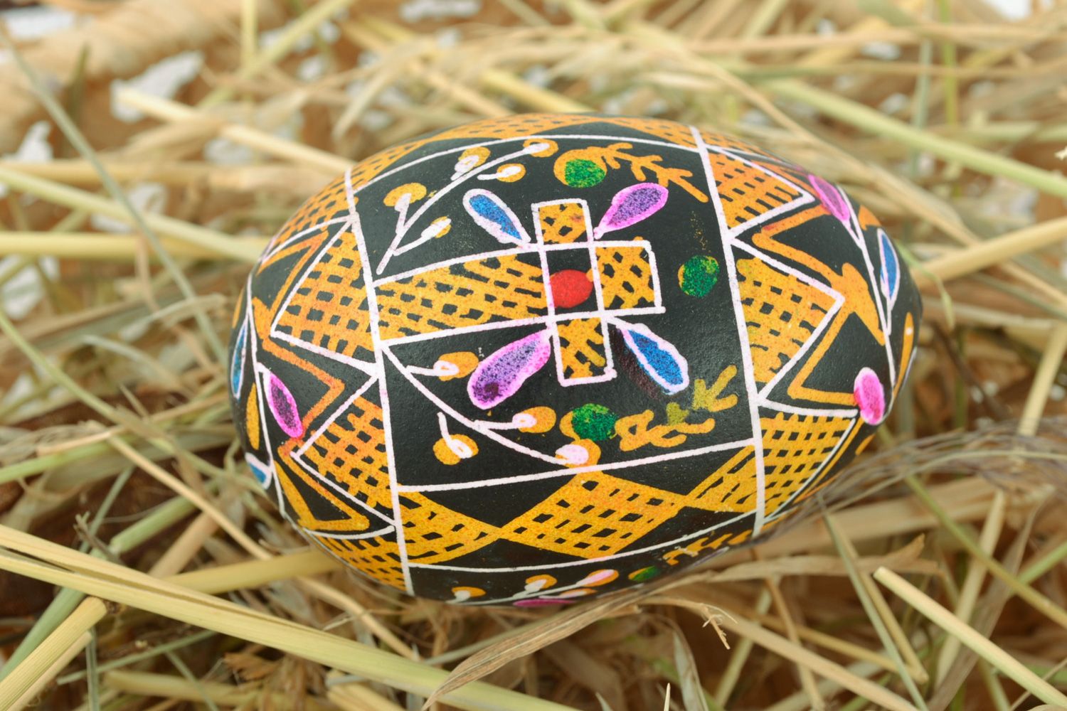 Handmade painted Easter egg pysanka with rich ornament made with hot wax  photo 1