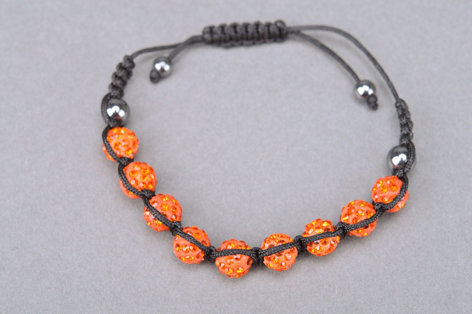 Bright orange handmade wrist bracelet woven of threads and beads with adjustable size photo 2