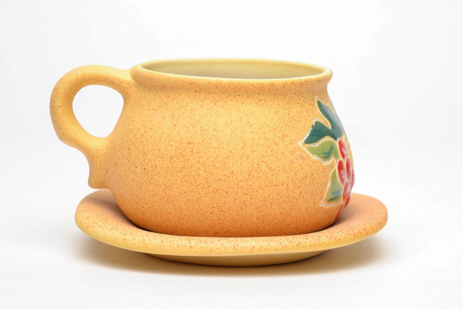 Yellow clay art teacup with handle and saucer and red floral pattern photo 3