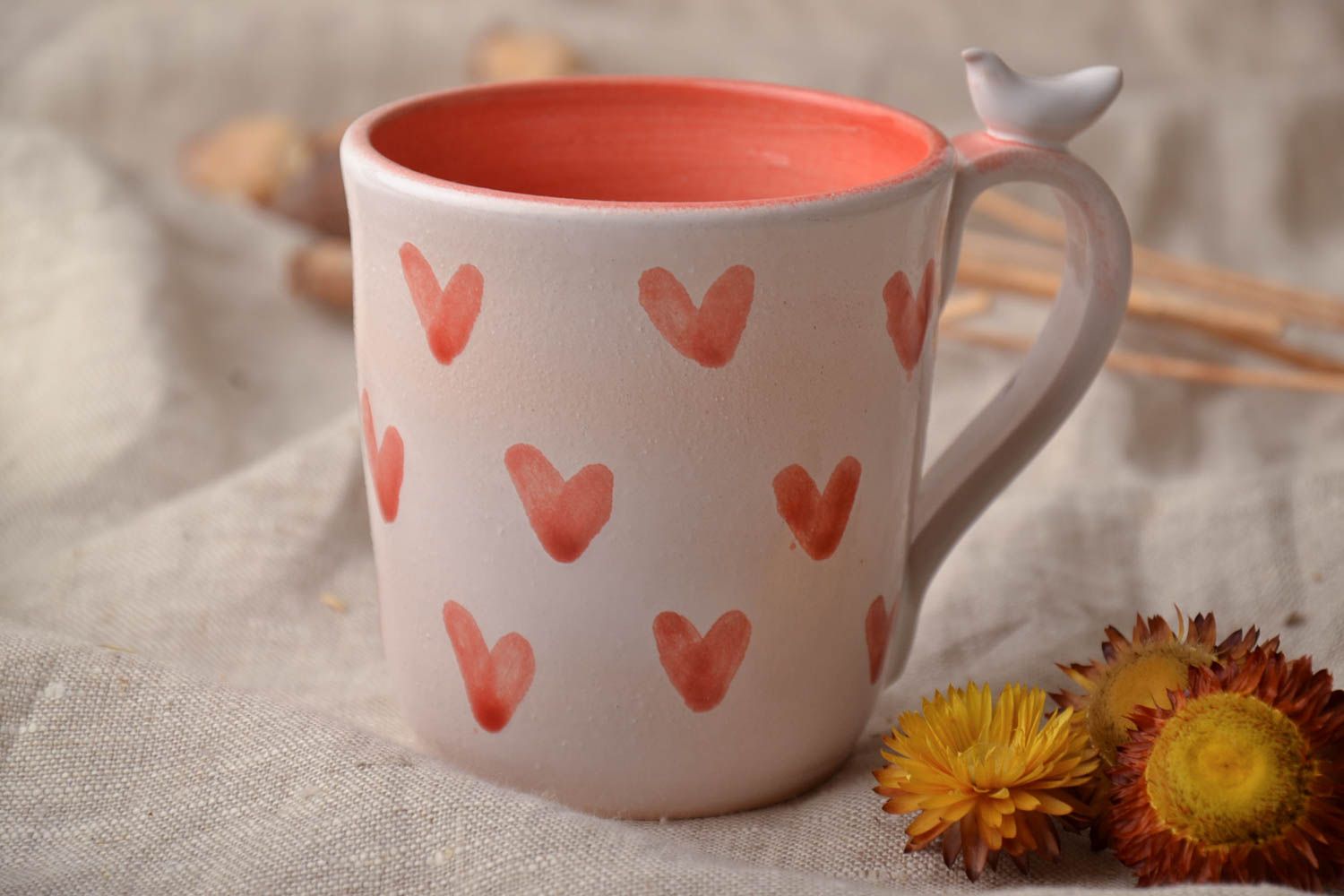 Ceramic handmade coffee cup with handle in white and orange color with hearts' pattern photo 1