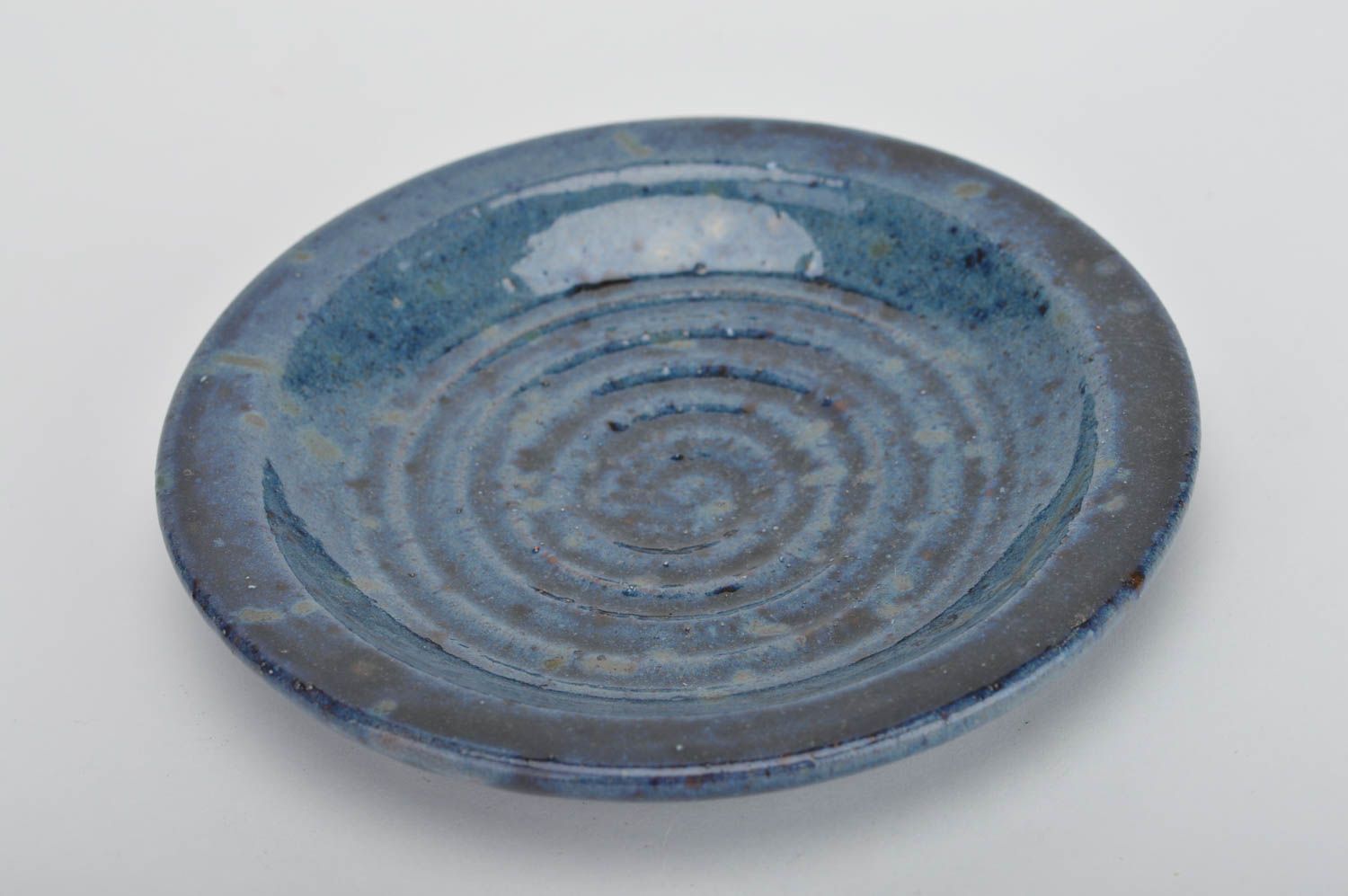 Handmade decorative round ceramic plate coated with glaze in deep blue color photo 2