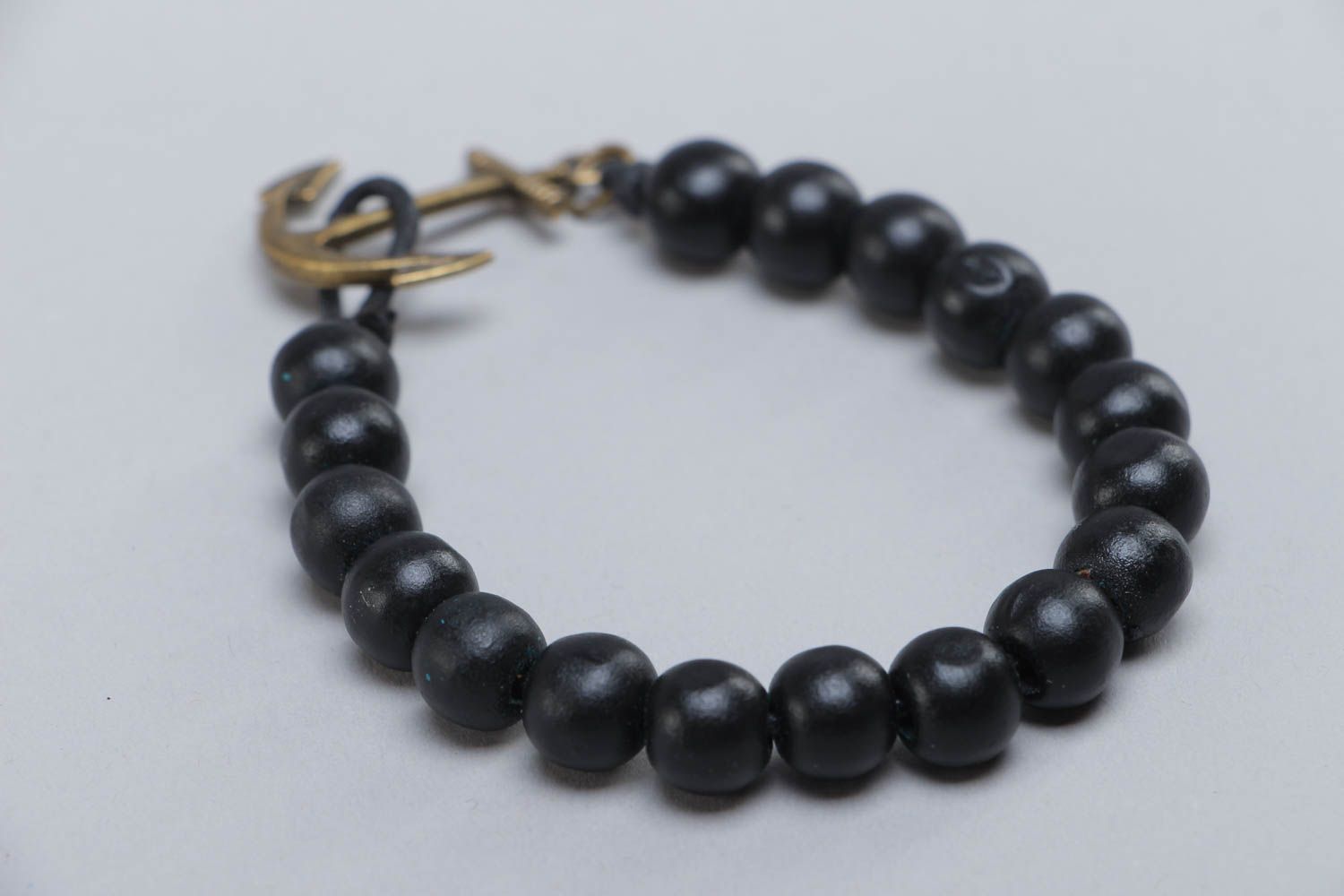 Handmade stylish black bracelet made of wooden beads with metal anchor photo 4
