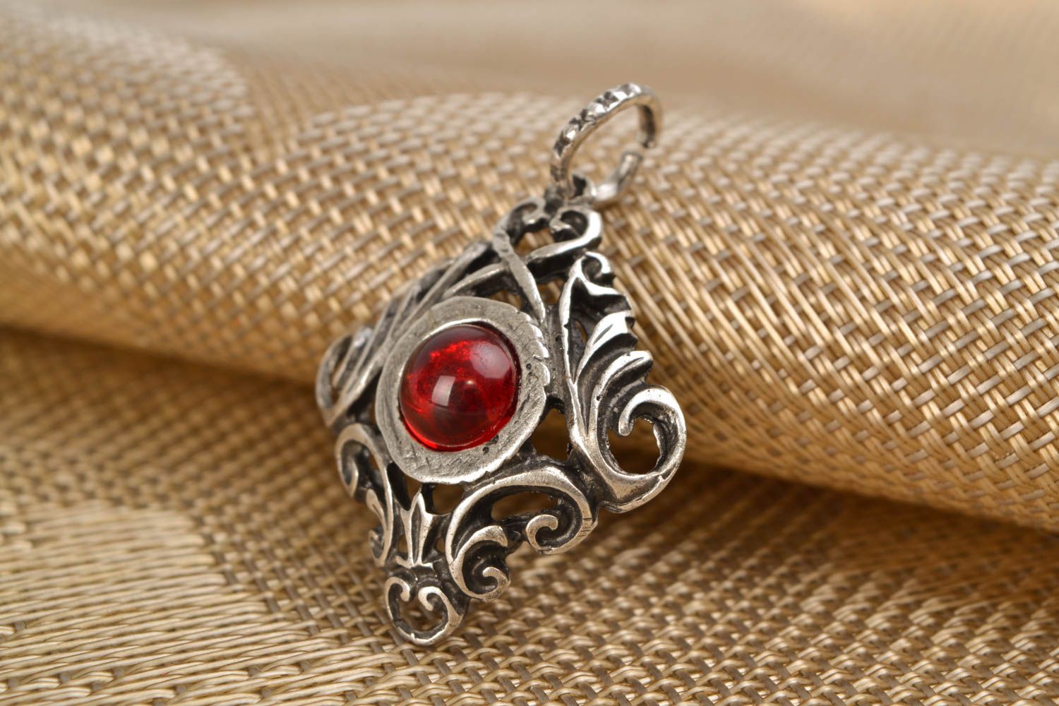 Metal pendant with red glass cabochon photo 1