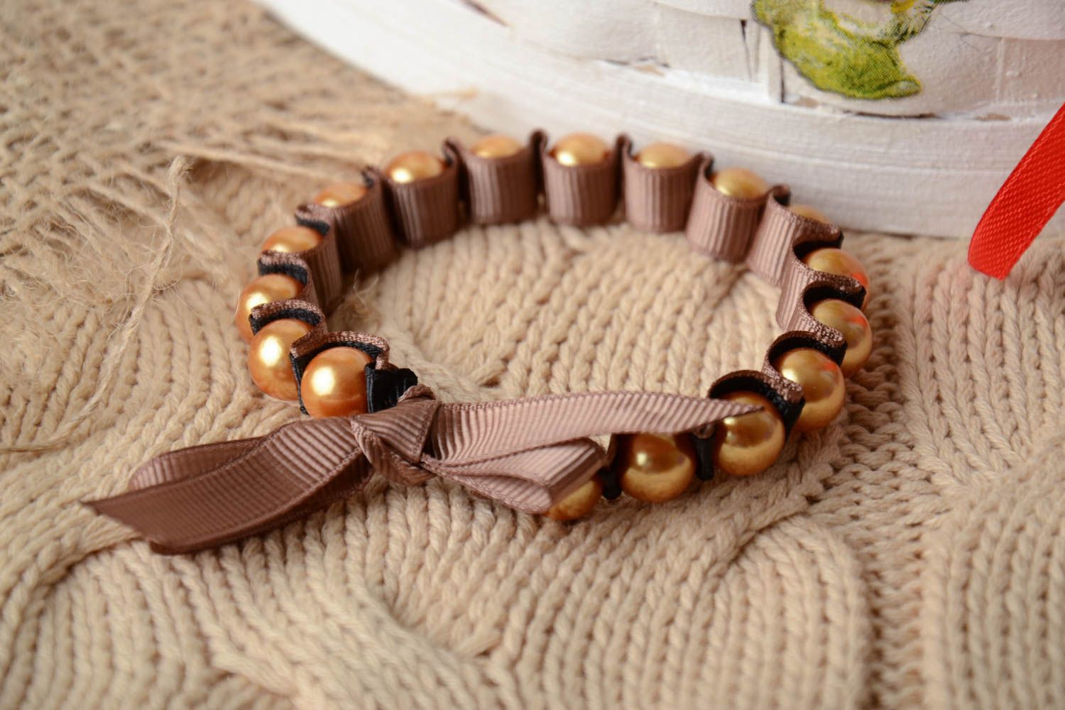Handmade thin laconic wrist bracelet with beads and rep ribbon of beige color photo 1