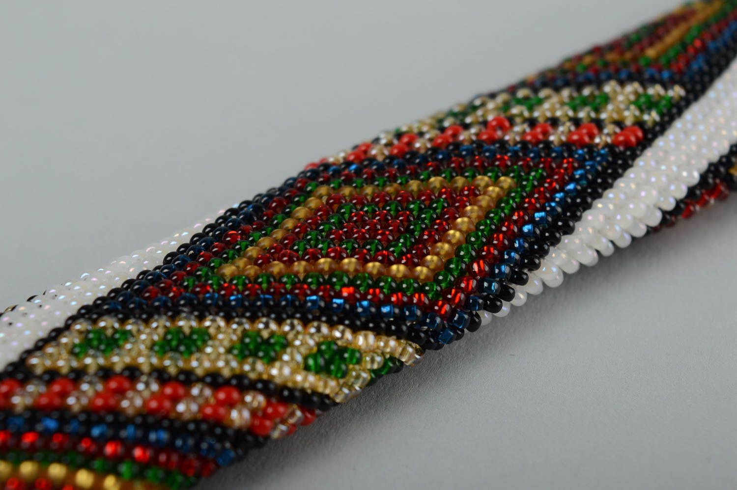 Delicate ethnic beaded bracelet in white, red, green colors for women photo 3