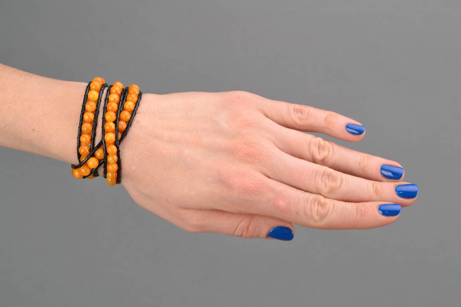 Orange leather beaded bracelet in three rows photo 2