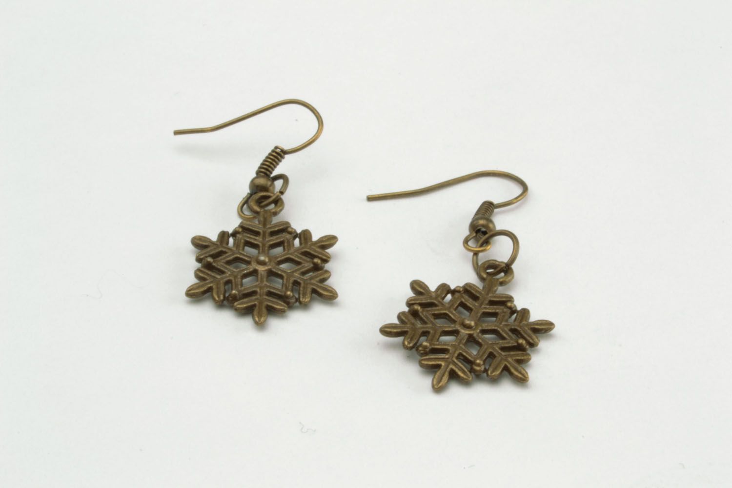 Metal earrings in the shape of snowflakes photo 5