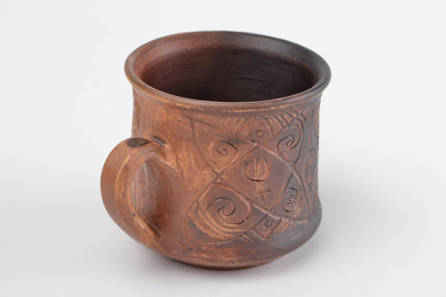 Clay cup for drinks in brown color with handle and cave symbols photo 4