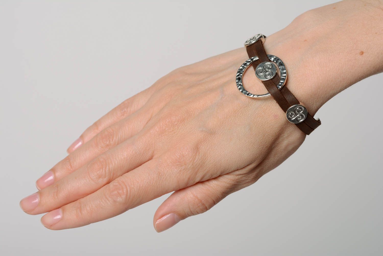Beautiful handmade designer brown genuine leather wrist bracelet with metal inserts photo 2