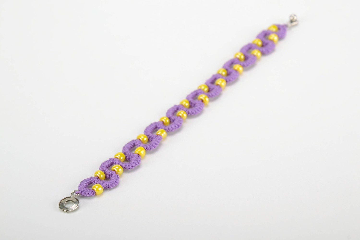Purple bracelet woven from threads photo 1
