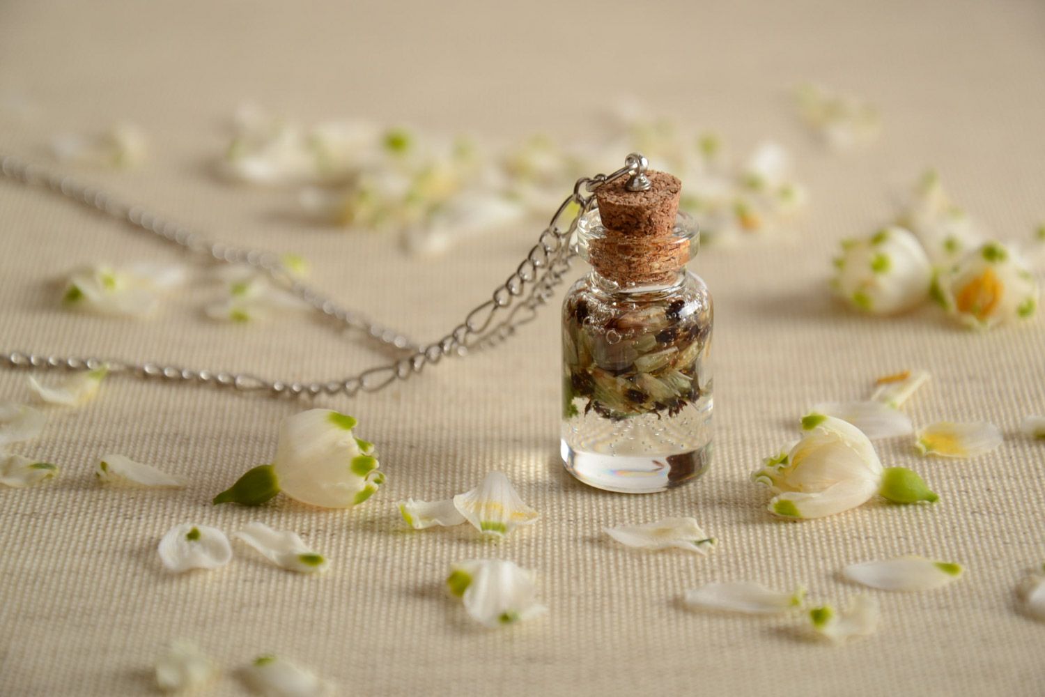 Handmade neck pendant with real flowers coated with epoxy in the shape of transparent vial photo 1