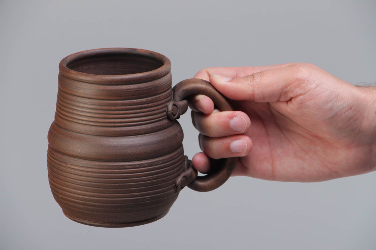 Homemade dark brown ceramic beer mug molded of red clay kilned with milk photo 5