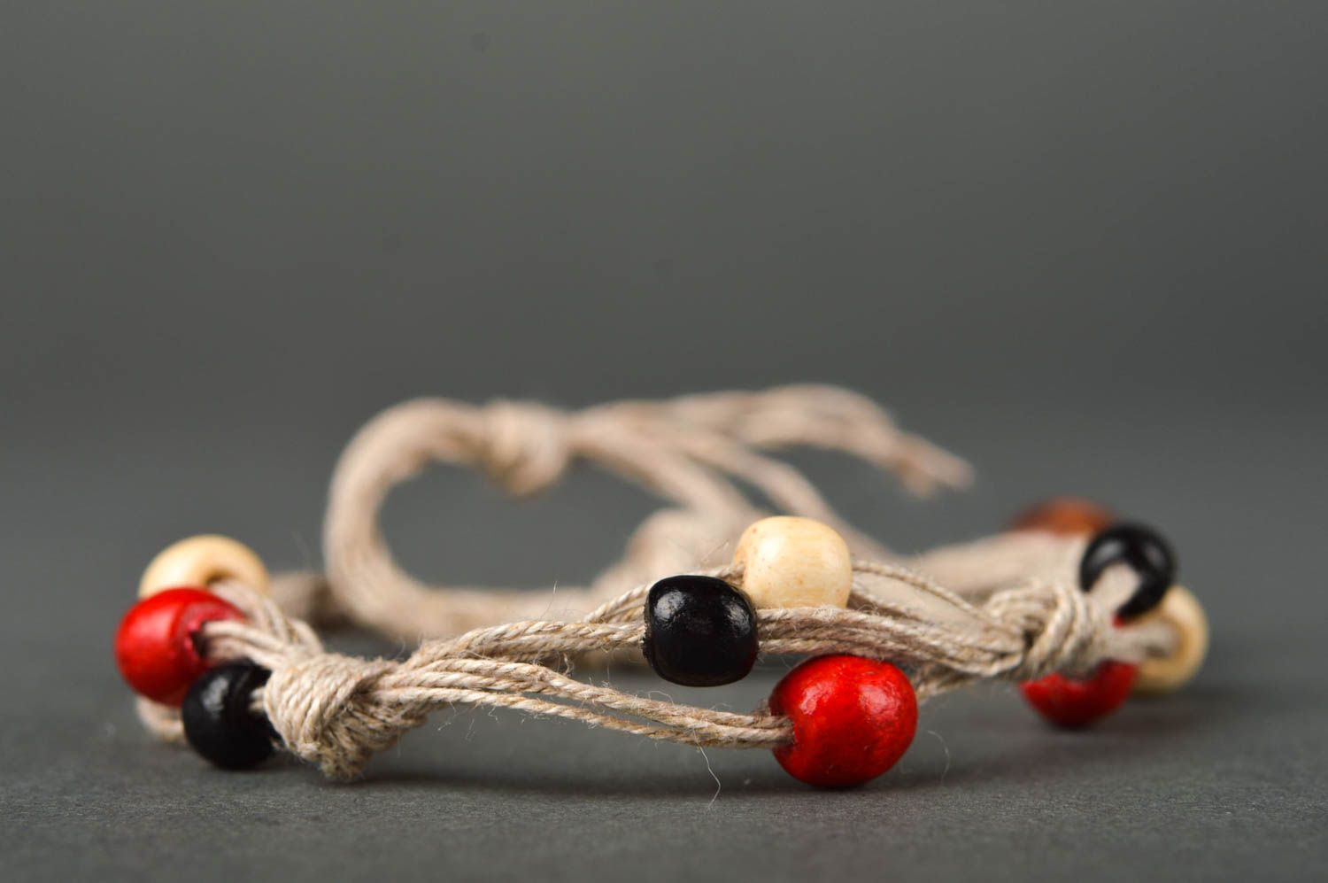 Strand beige rope two-row bracelet with red, black, white, yellow wooden beads for women photo 3