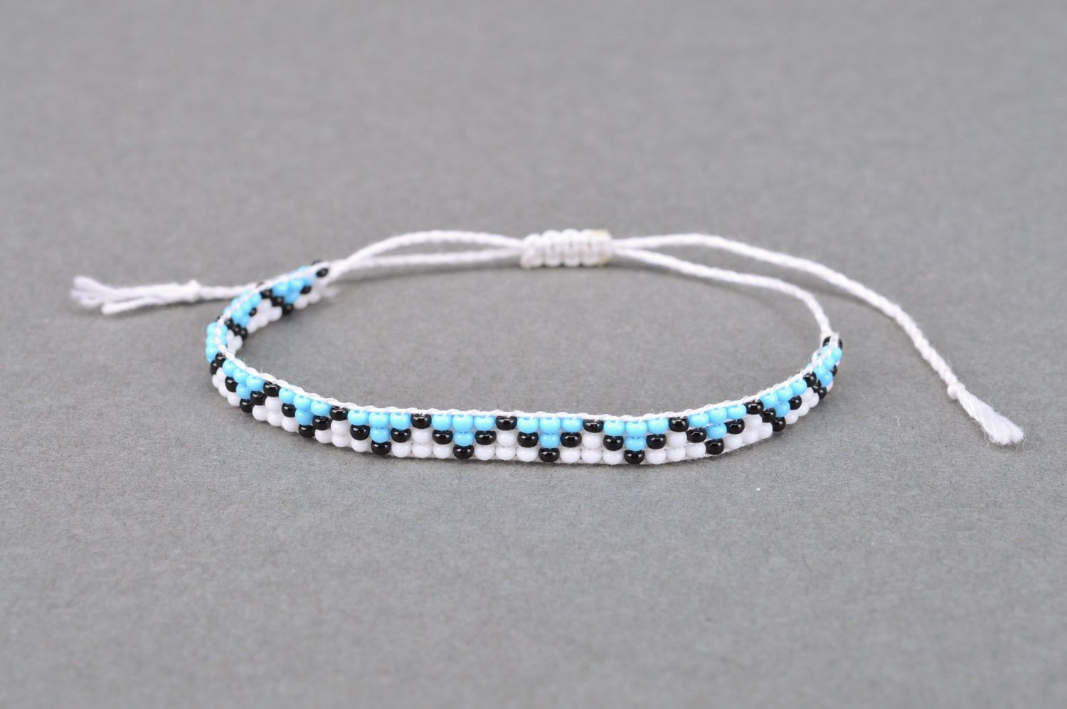 Handmade light thin wrist bracelet woven of beads and threads with ornament photo 2