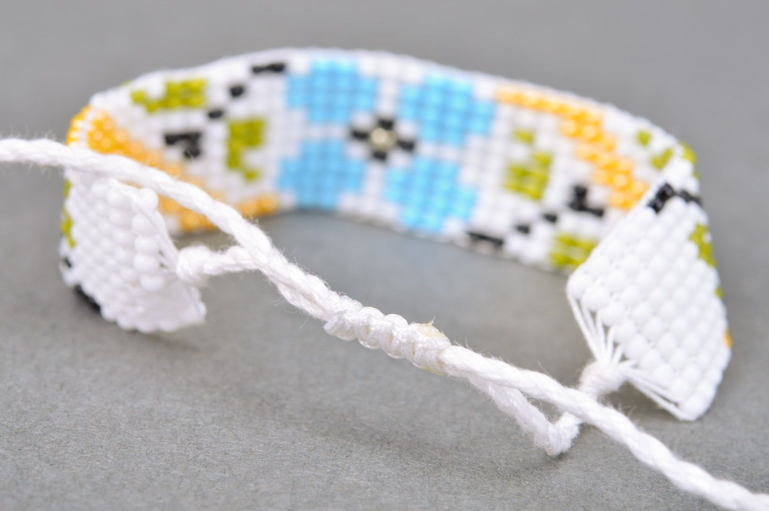 Handmade women's woven bead bracelet with ties White with Flowers photo 4