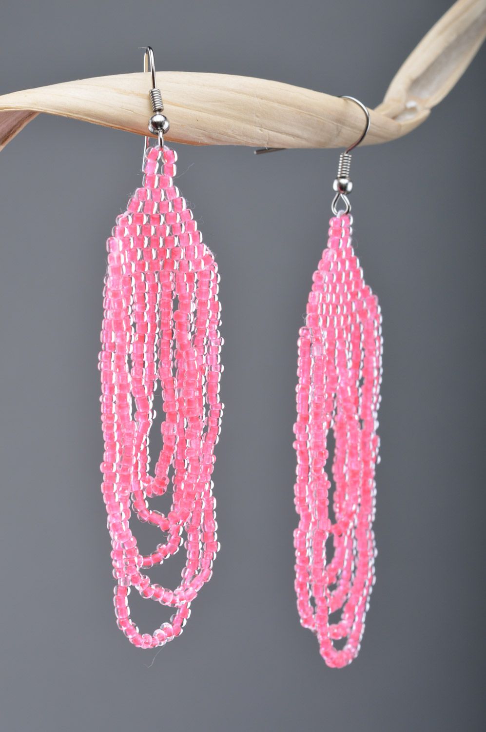 Handmade long dangle earrings woven of Czech beads of bright pink color photo 1
