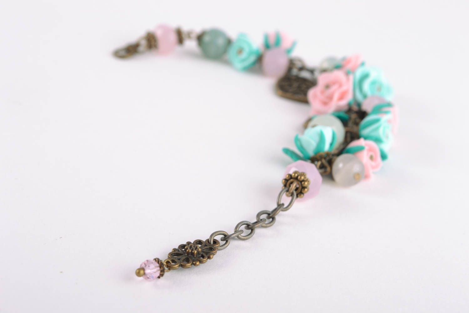 Charm bracelet with pink and turquoise roses and bronze charms photo 1