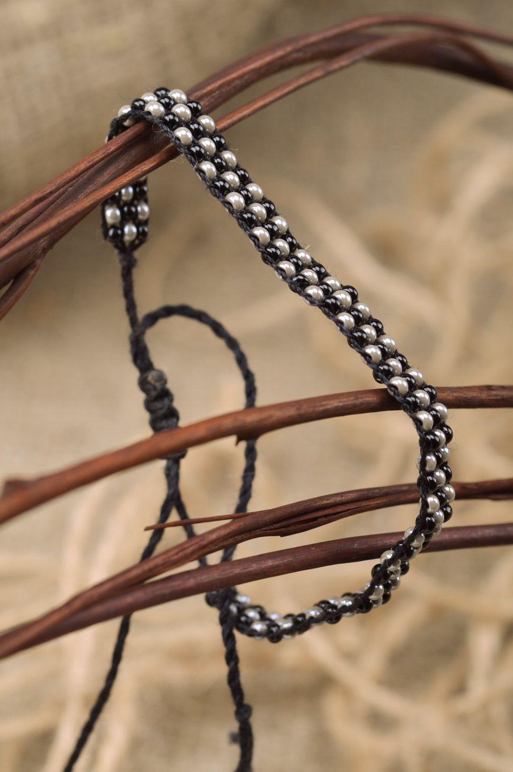 Handmade wrist bracelet woven of black and nacre beads with ties for women photo 1