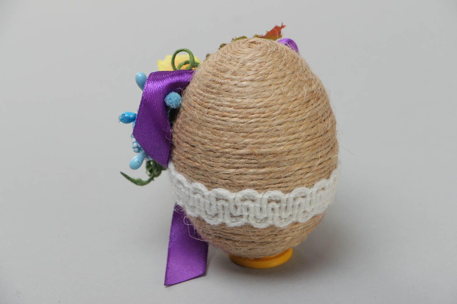 Wooden handmade Easter decorative egg wrapped with twine with flowers and lace photo 3