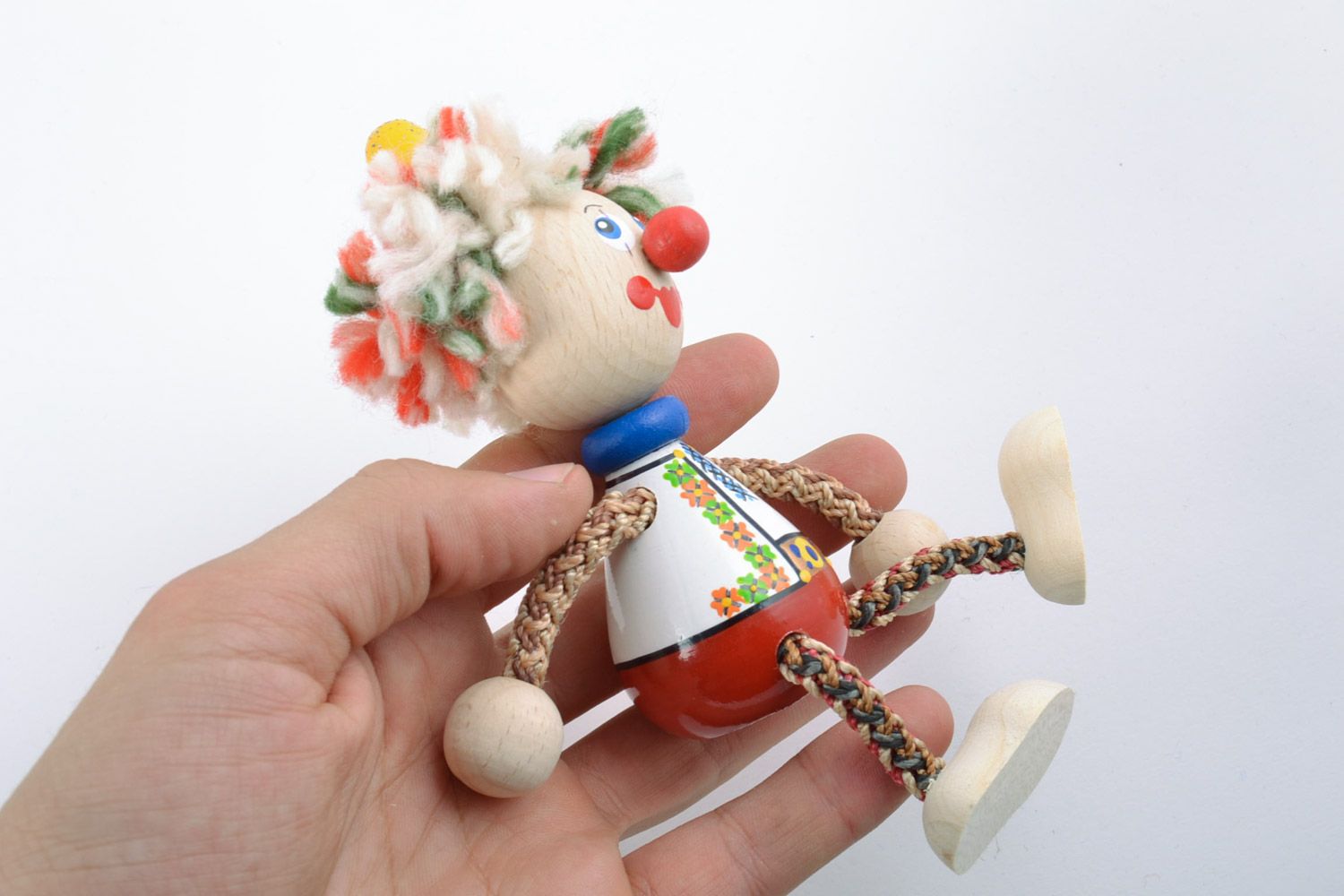 Bright homemade painted wooden toy in the shape of clown photo 2