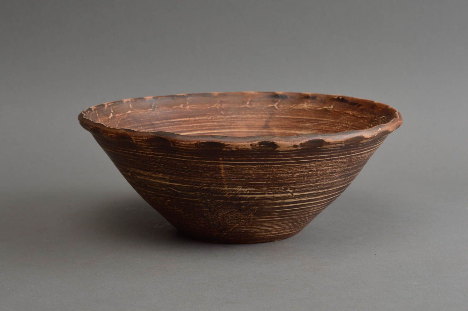 Handmade narrow brown salad bowl made of red clay using milk firing technique photo 2