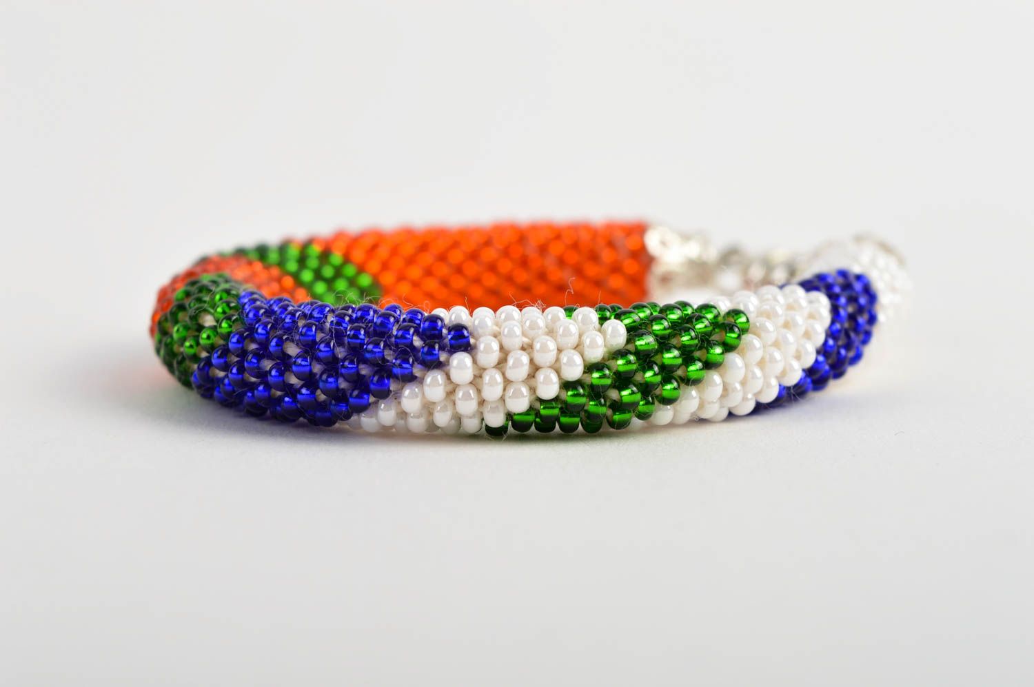 Bright handmade beaded bracelet in red, white, green, blue colors photo 4