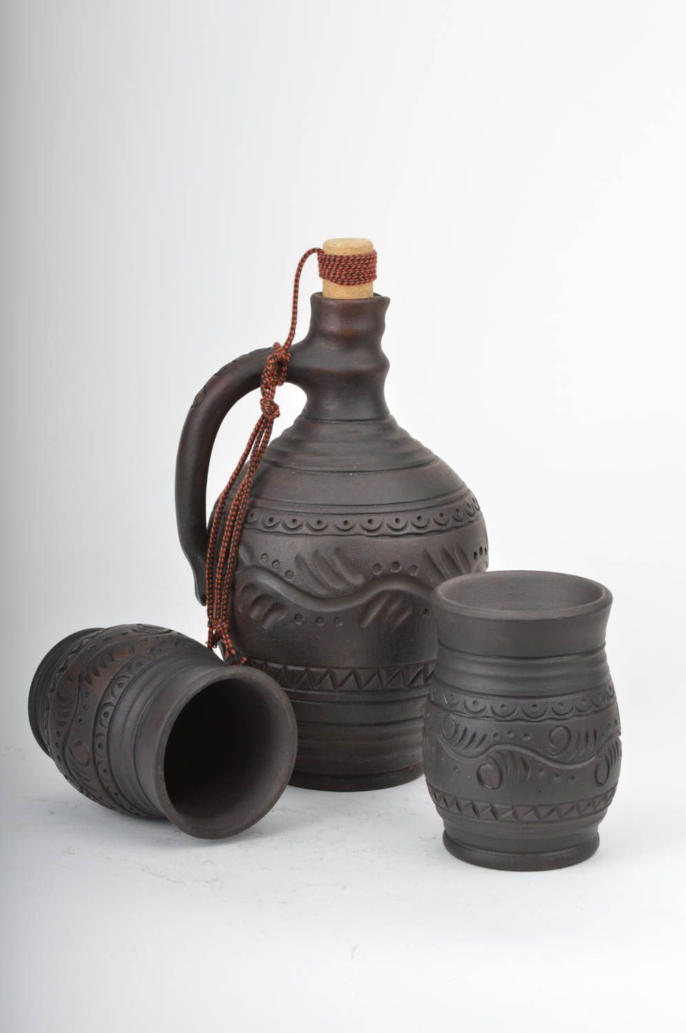 Set of dark brown ceramic drinkware pottery of wine bottle and two wine cups with rustic pattern photo 5