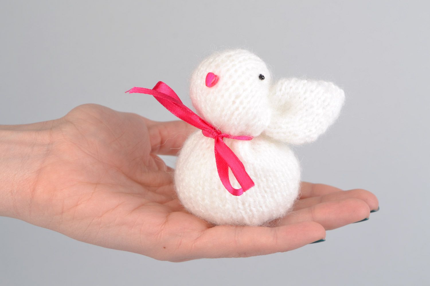 Handmade soft toy knitted of angora wool in the shape of white rabbit with pink bow photo 2