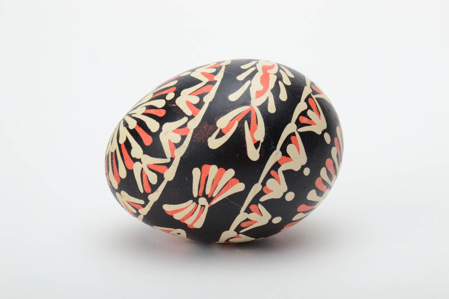 Handmade painted Easter egg of black color with patterns waxing technique photo 3