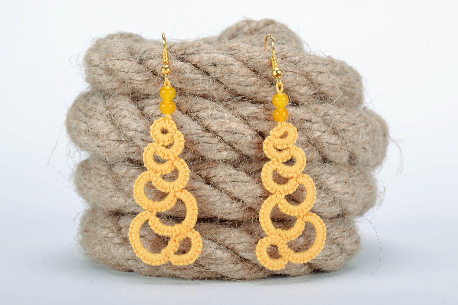 Orange earrings made from woven lace photo 1