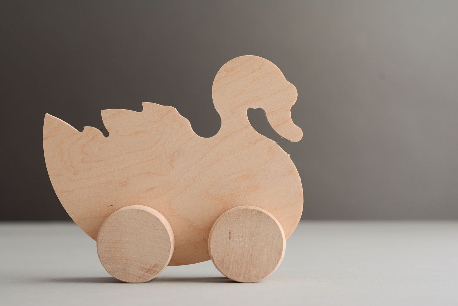 Wooden toy with wheels Swan photo 1