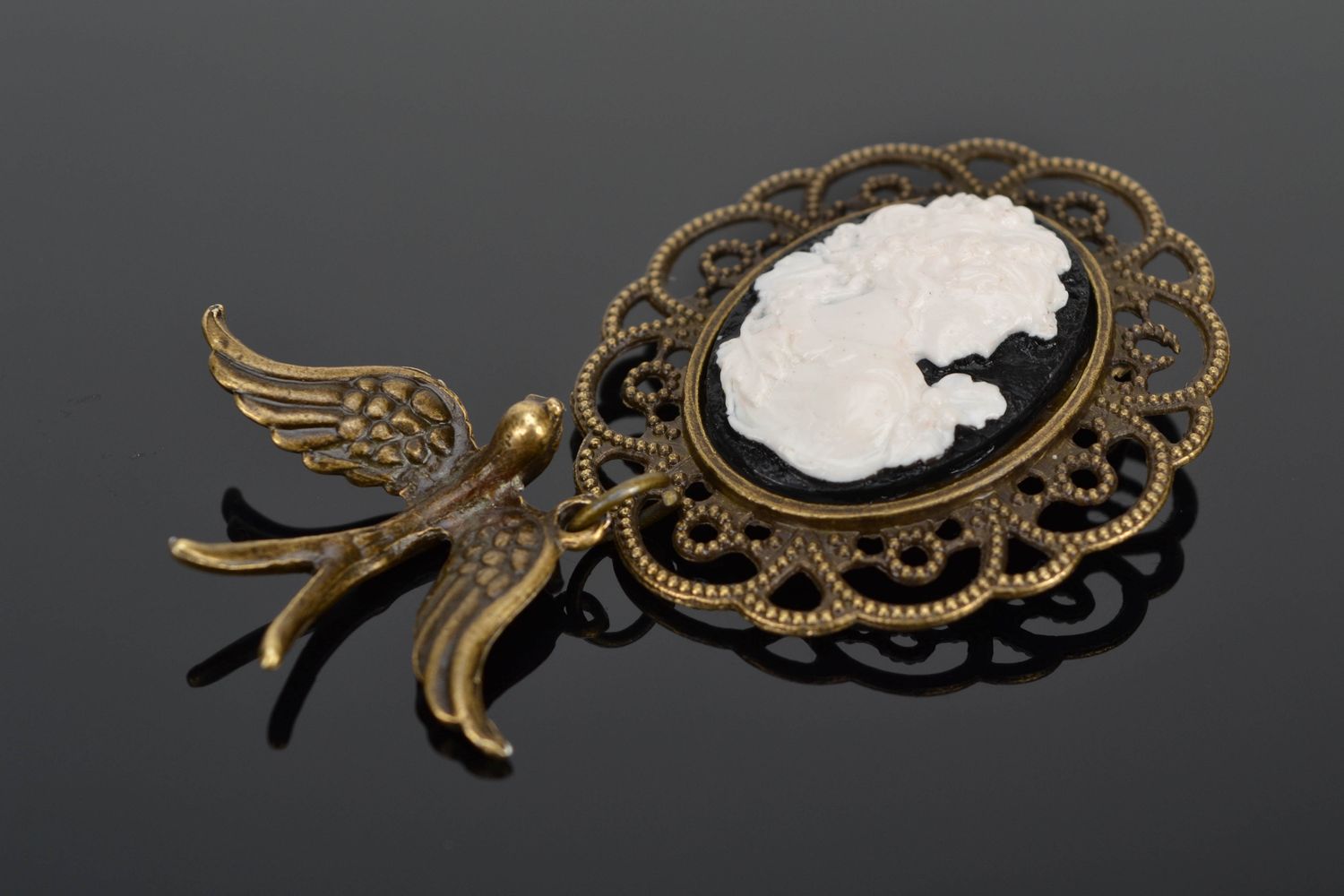 Vintage metal brooch with cameo and swallow photo 1
