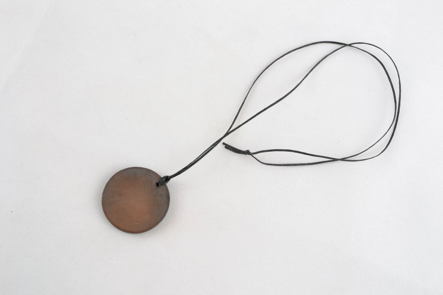 Round pendant made of black smoked ceramics photo 4