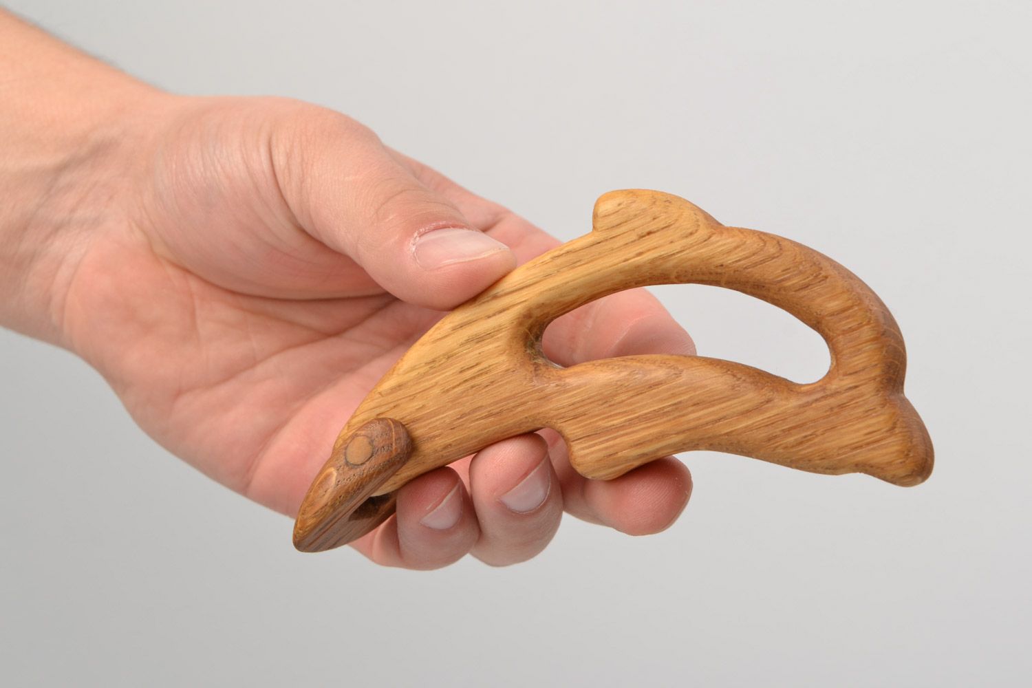 Handmade wooden teething toy in the shape of dolphin imbued with linseed oil photo 2