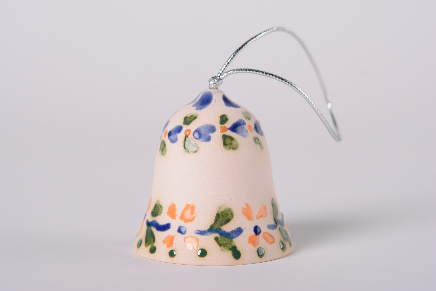 Handmade decorative light maiolica ceramic hanging bell ornamented with glaze photo 1