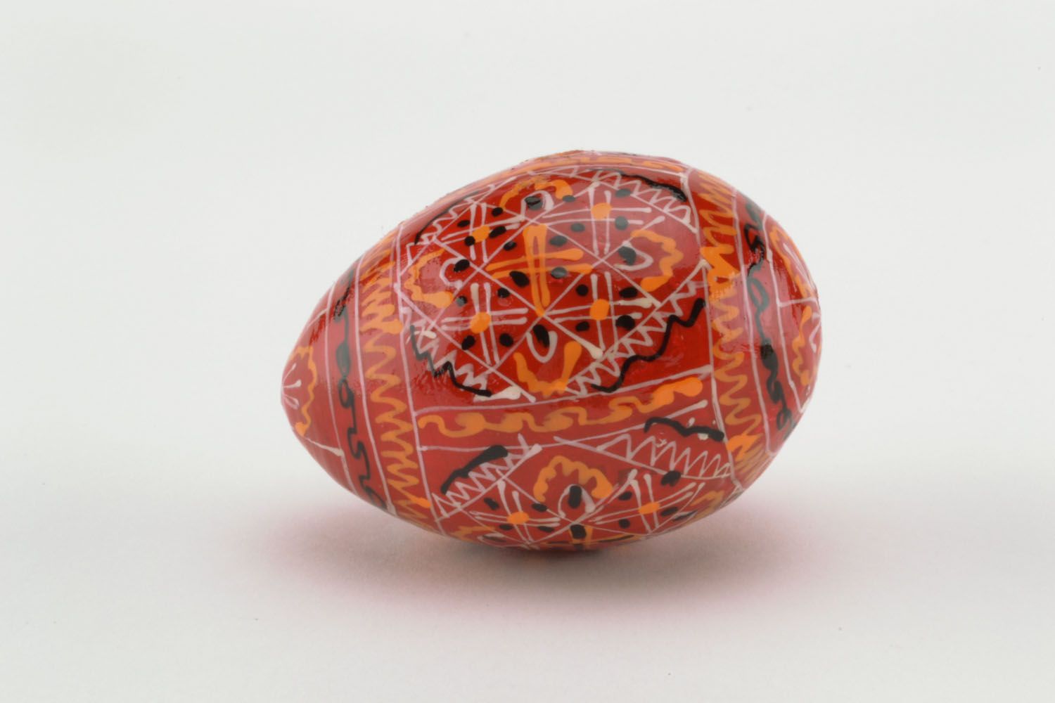 Wooden egg in red colors photo 2