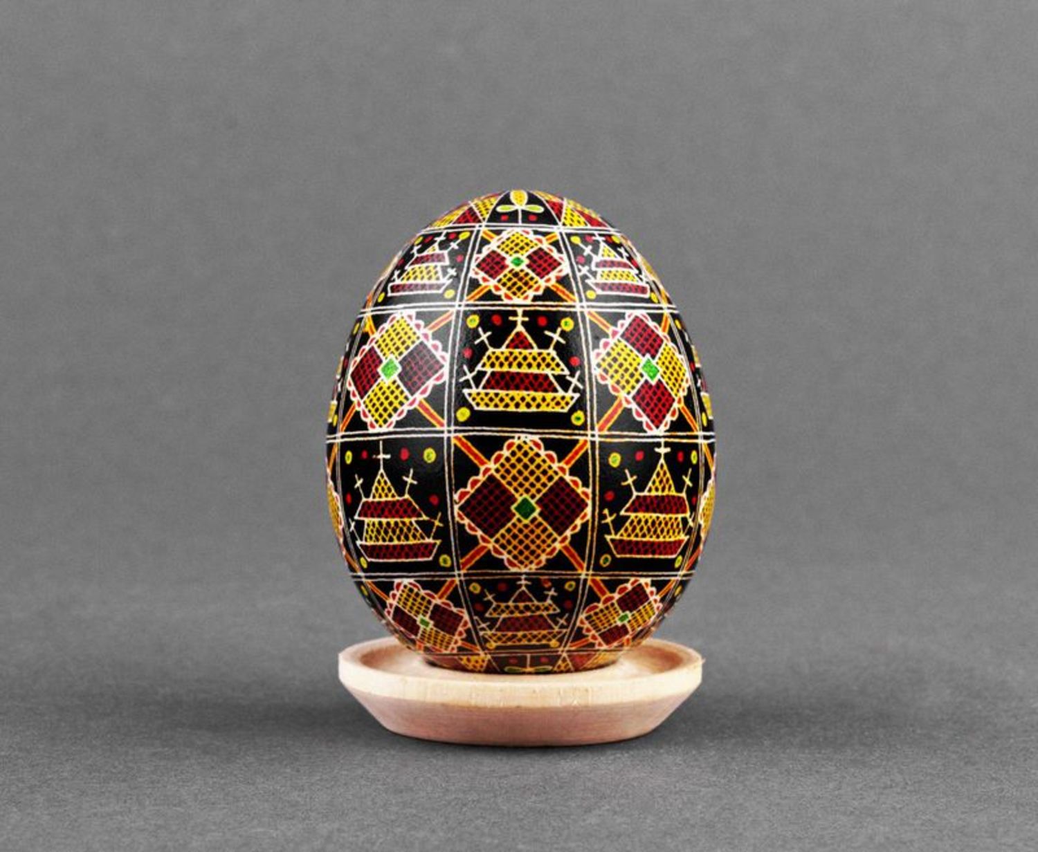 Black pysanka with red and yellow ornament photo 2