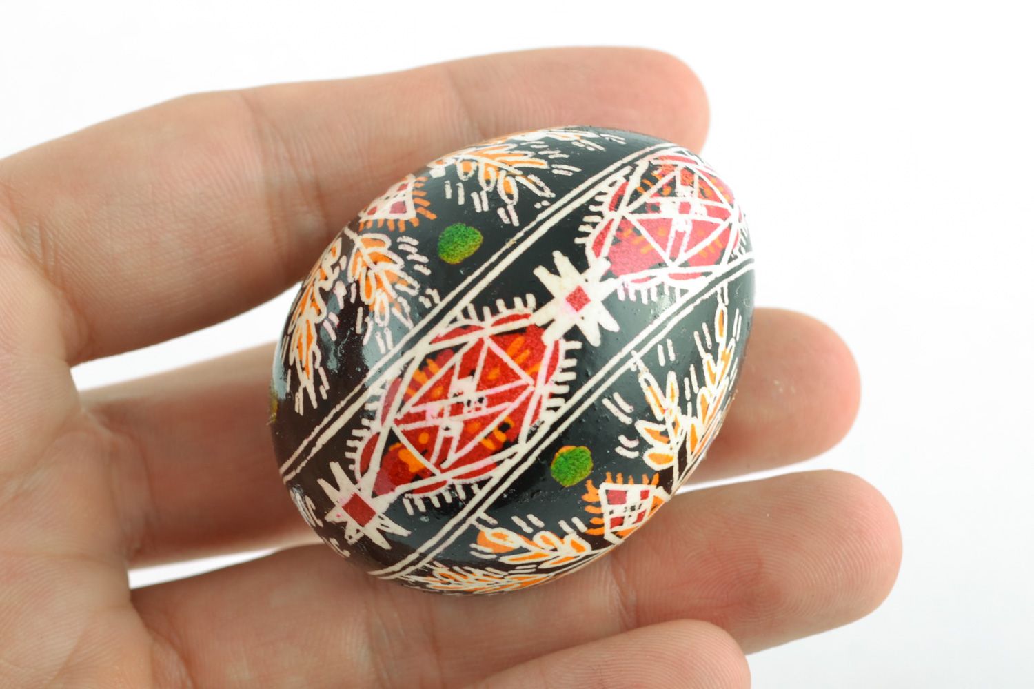 Handmade Easter egg with rich ornament on black background painted with hot wax  photo 5