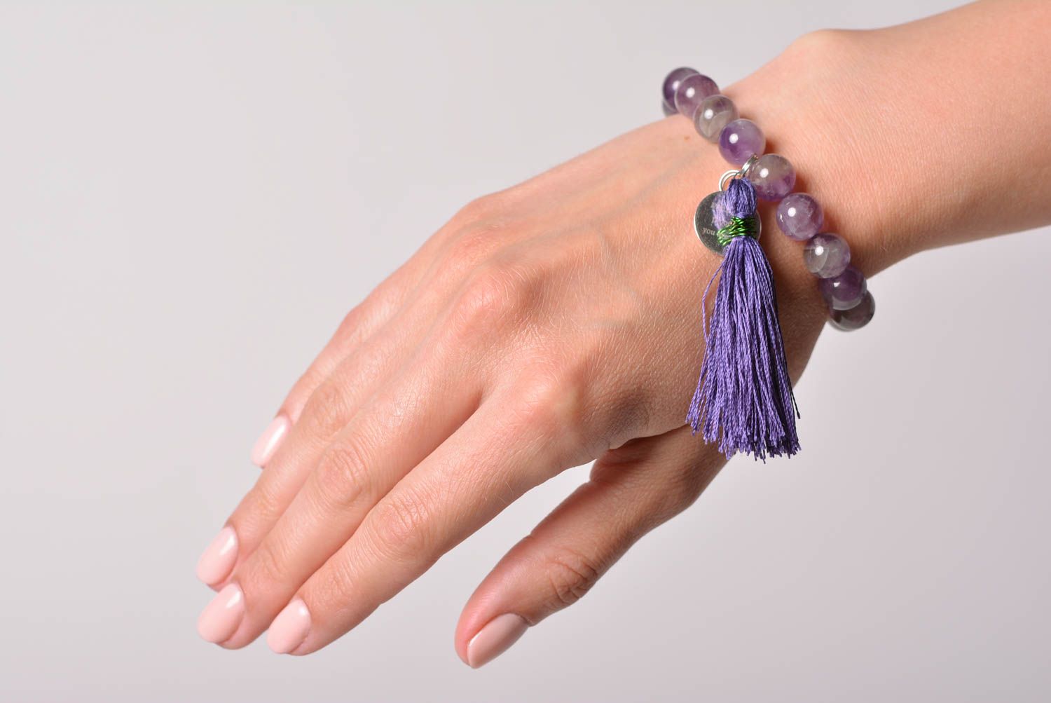Handmade tender wrist bracelet with amethyst beads and thread tassel for women photo 1