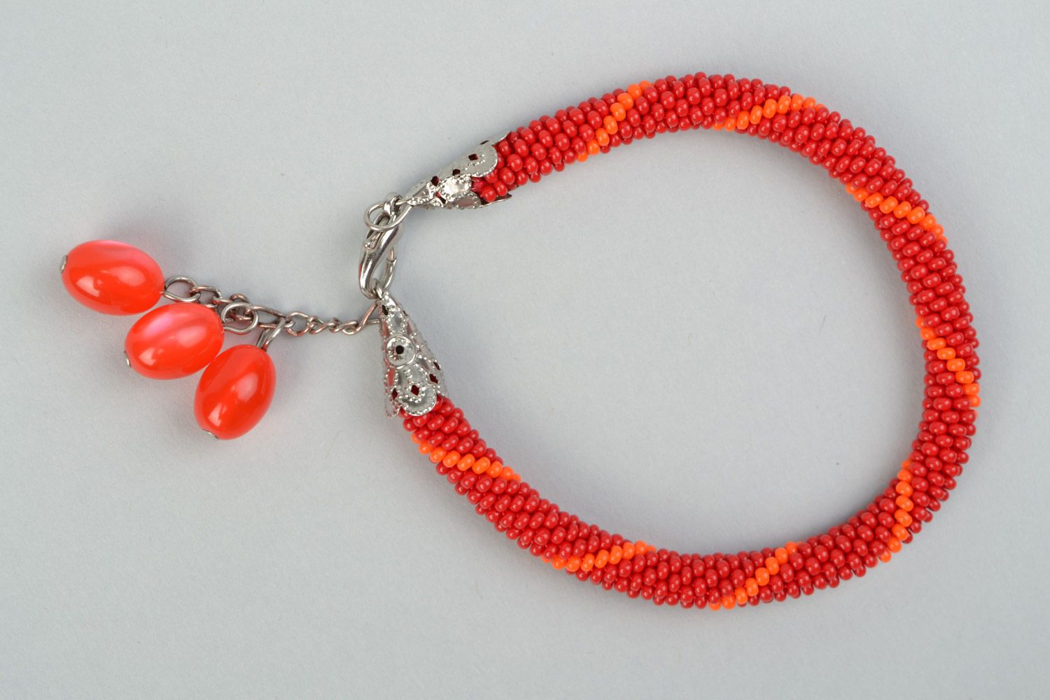 Handmade designer wrist bracelet woven of Czech beads in red color palette photo 2