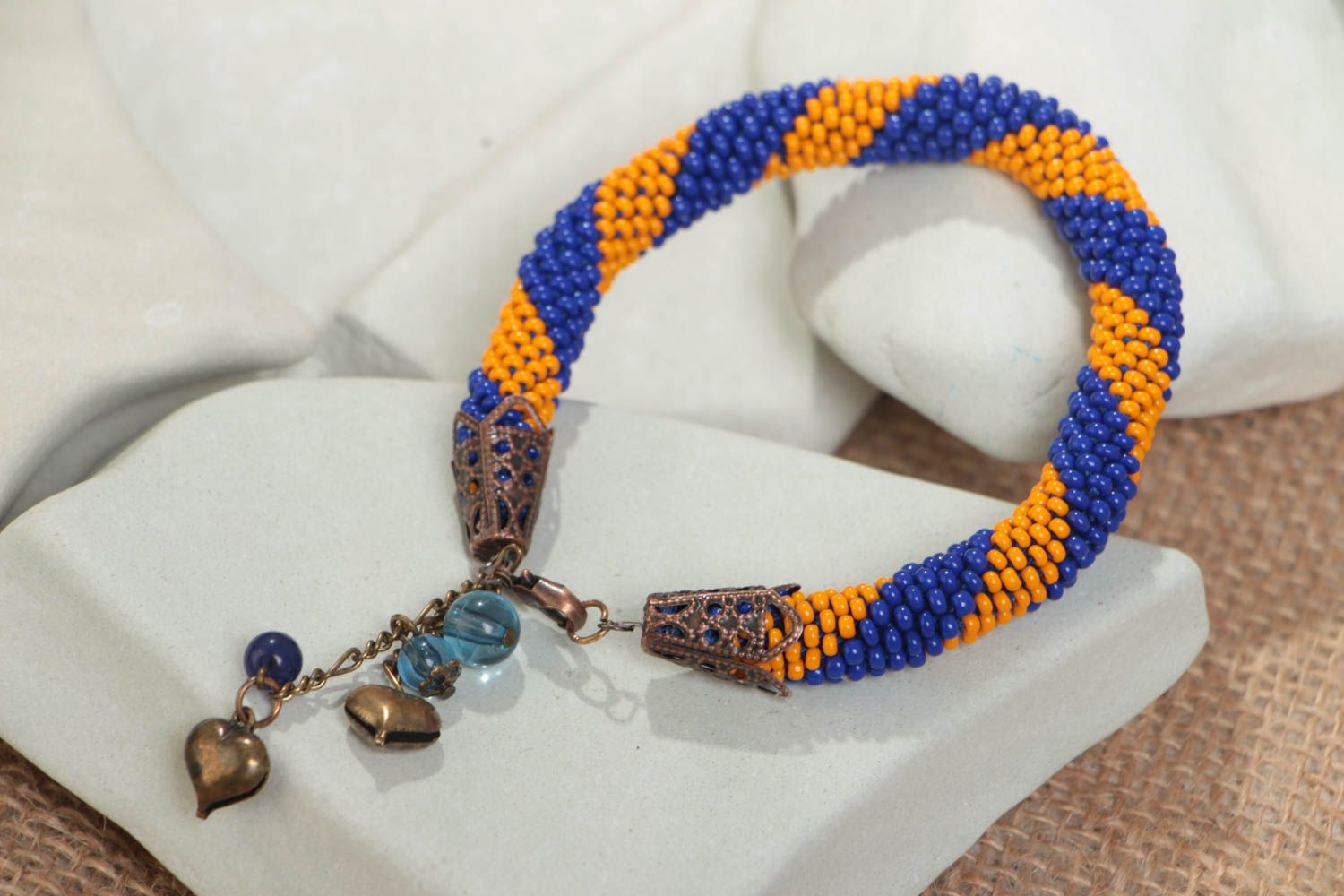 Handmade designer striped blue and yellow beaded cord wrist bracelet with charms photo 1
