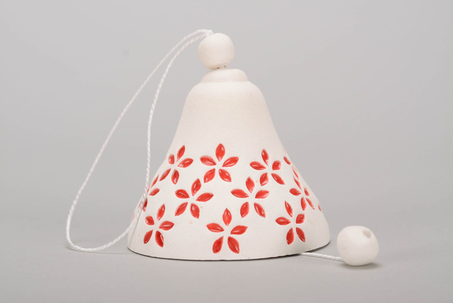 White clay bell with embossed elements photo 3