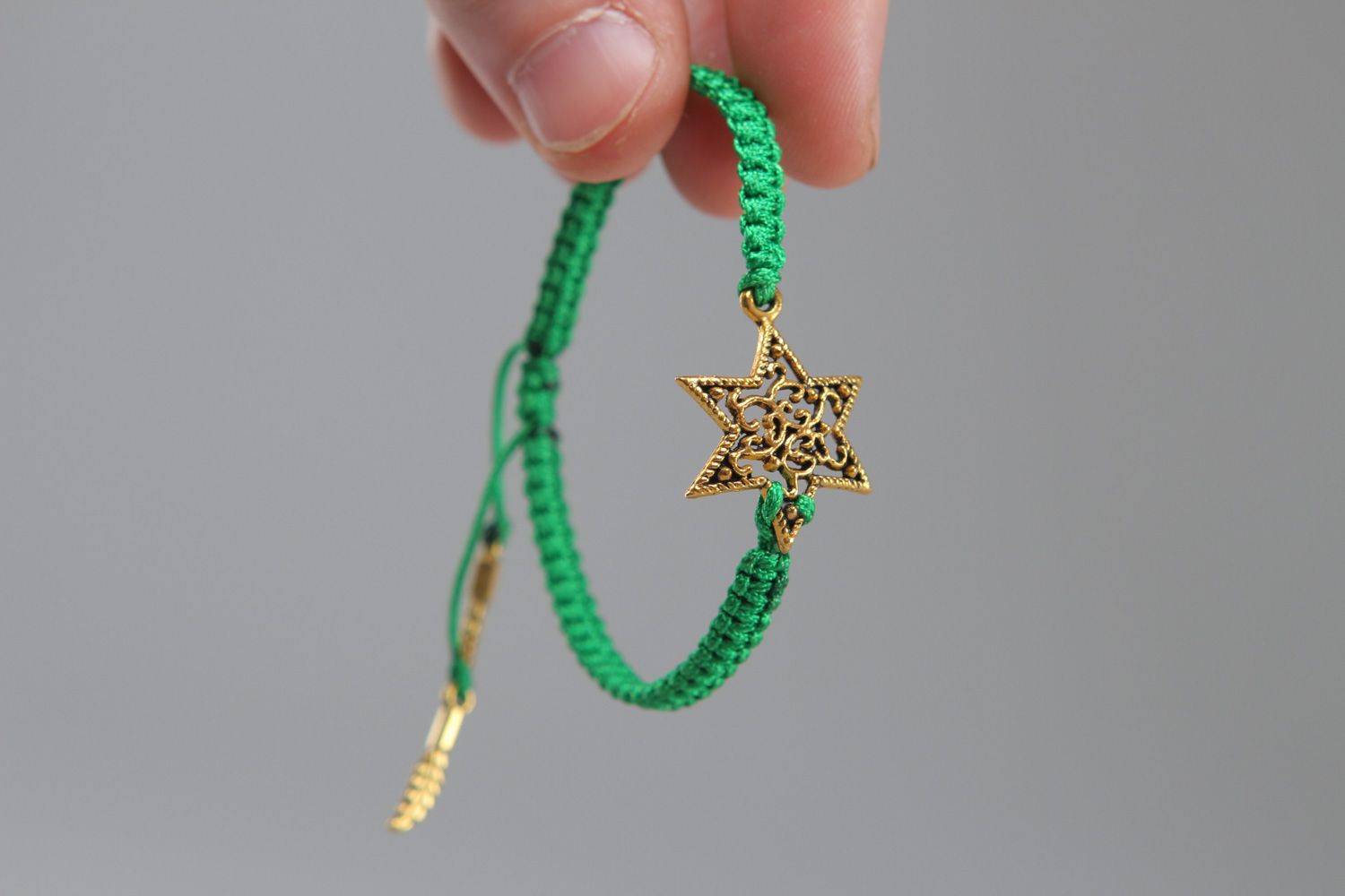 Handmade friendship bracelet woven of green cord with metal star for girls photo 3