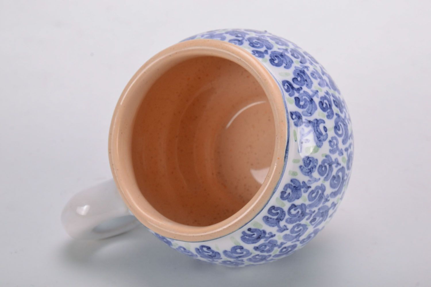 Handmade clay glazed drinking cup in white and blue color with violets' pattern photo 3