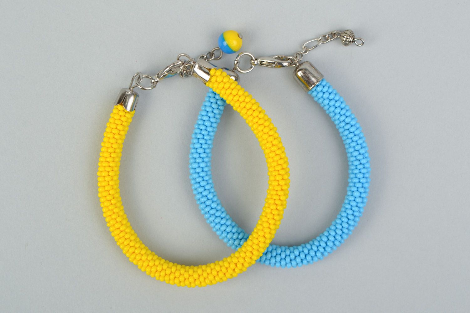 Set of 2 handmade beaded cord wrist bracelets of yellow and blue colors  photo 2